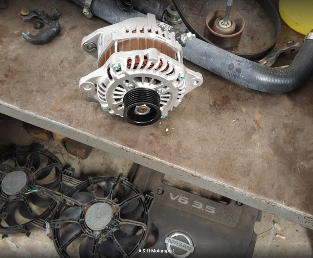 A new or cleaned alternator placed on a table, ready for installation in a vehicle
