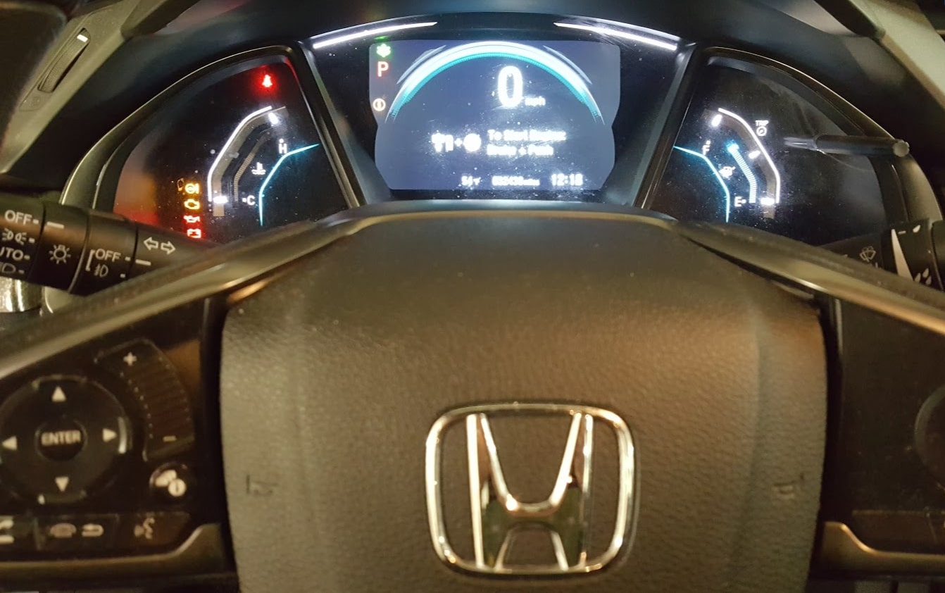 The front steering part of a Honda Civic, with the speed meter visible in the dashboard