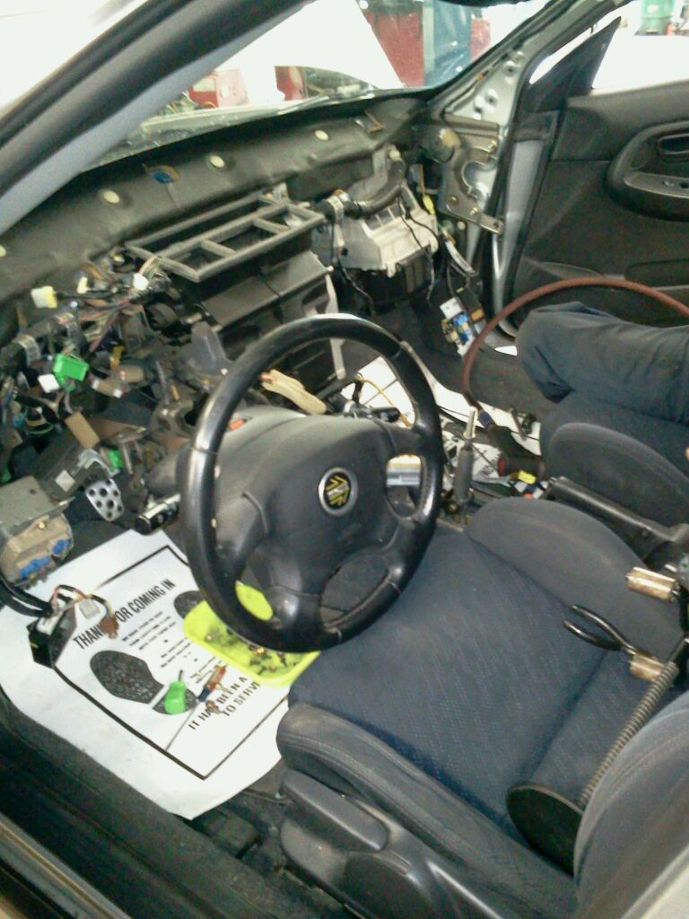 Car steering undergoing repair, indicating maintenance and upkeep of the vehicle